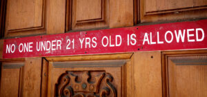 sign on door reading no one under 21 yrs old is allowed