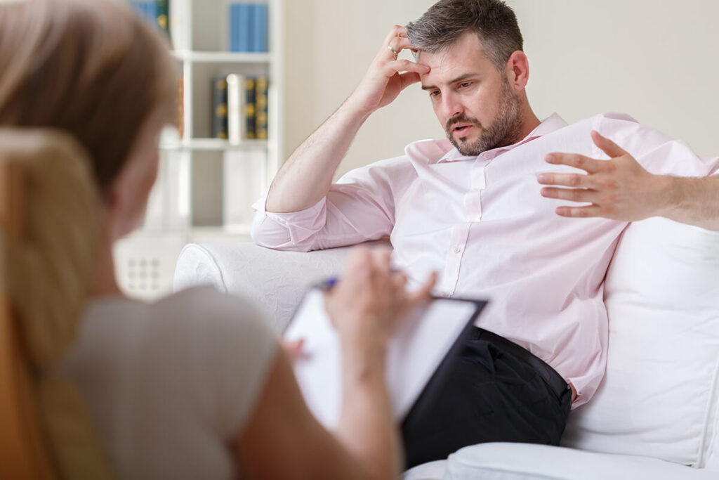 man talking with therapist about signs of addiction