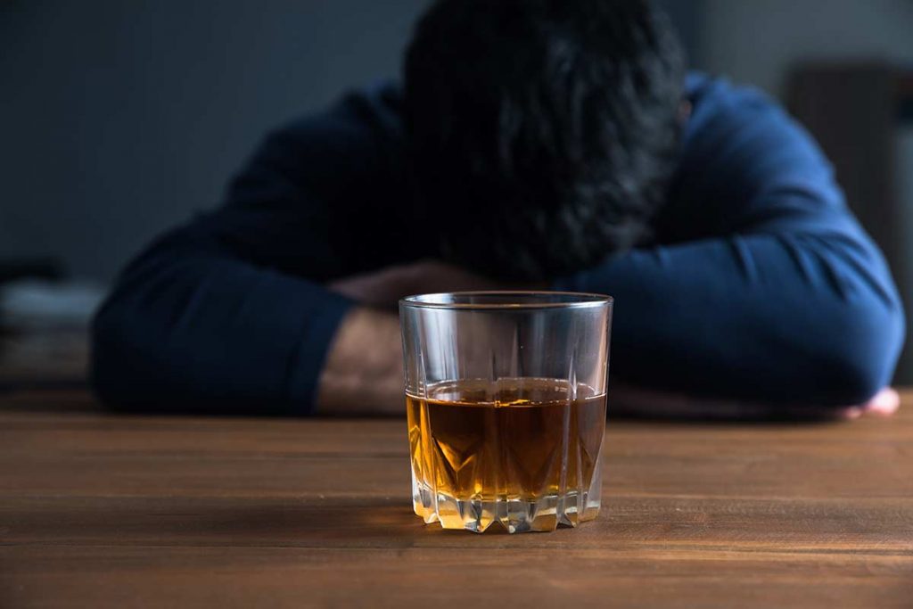 man struggling with alcoholism due to stress
