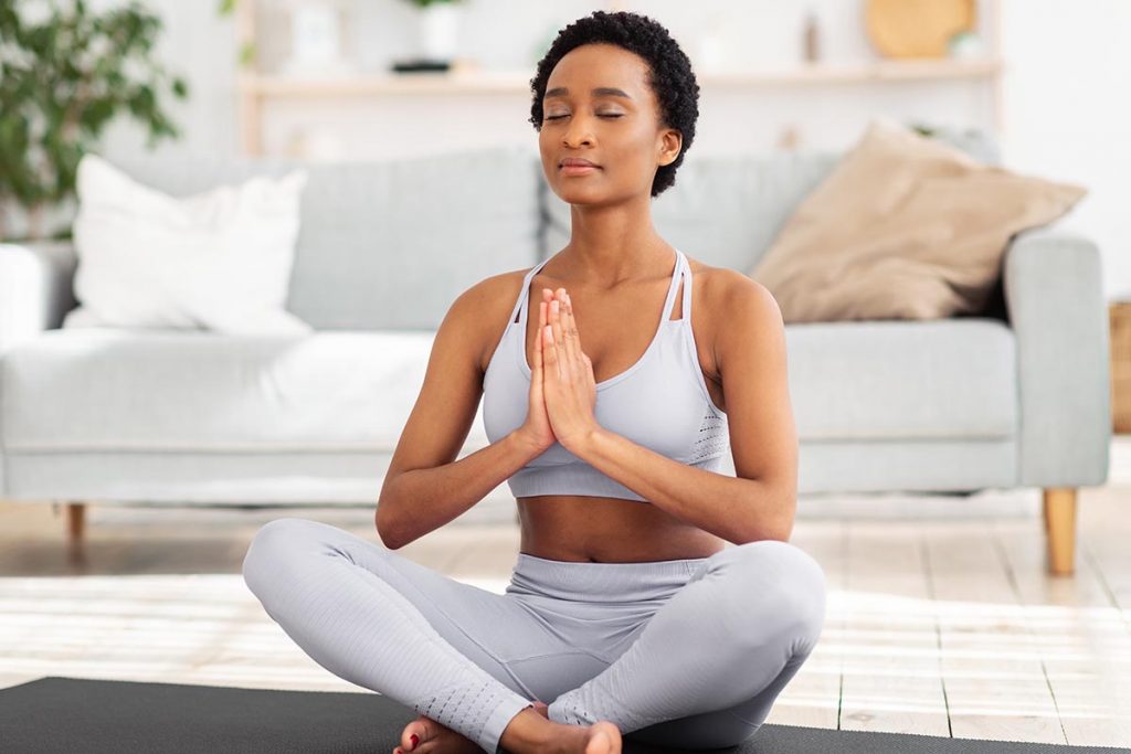 woman practicing yoga during minority mental health awareness month