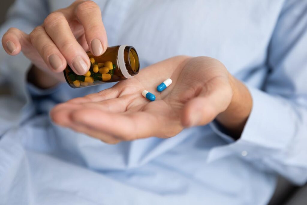 pills in hand representing 5 Signs You Need Prescription Drug Treatment