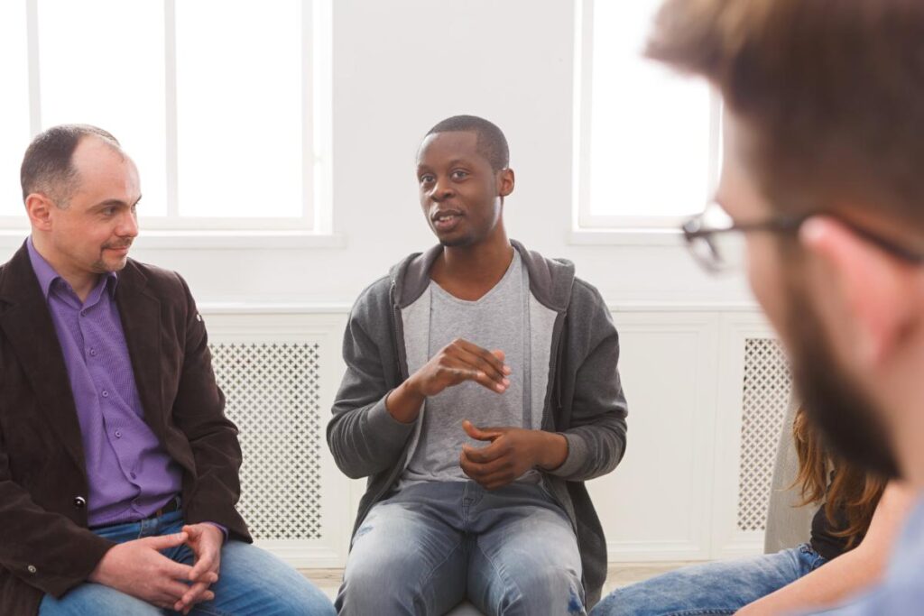 men in therapy talking about How to Choose a Men's Addiction Treatment Program